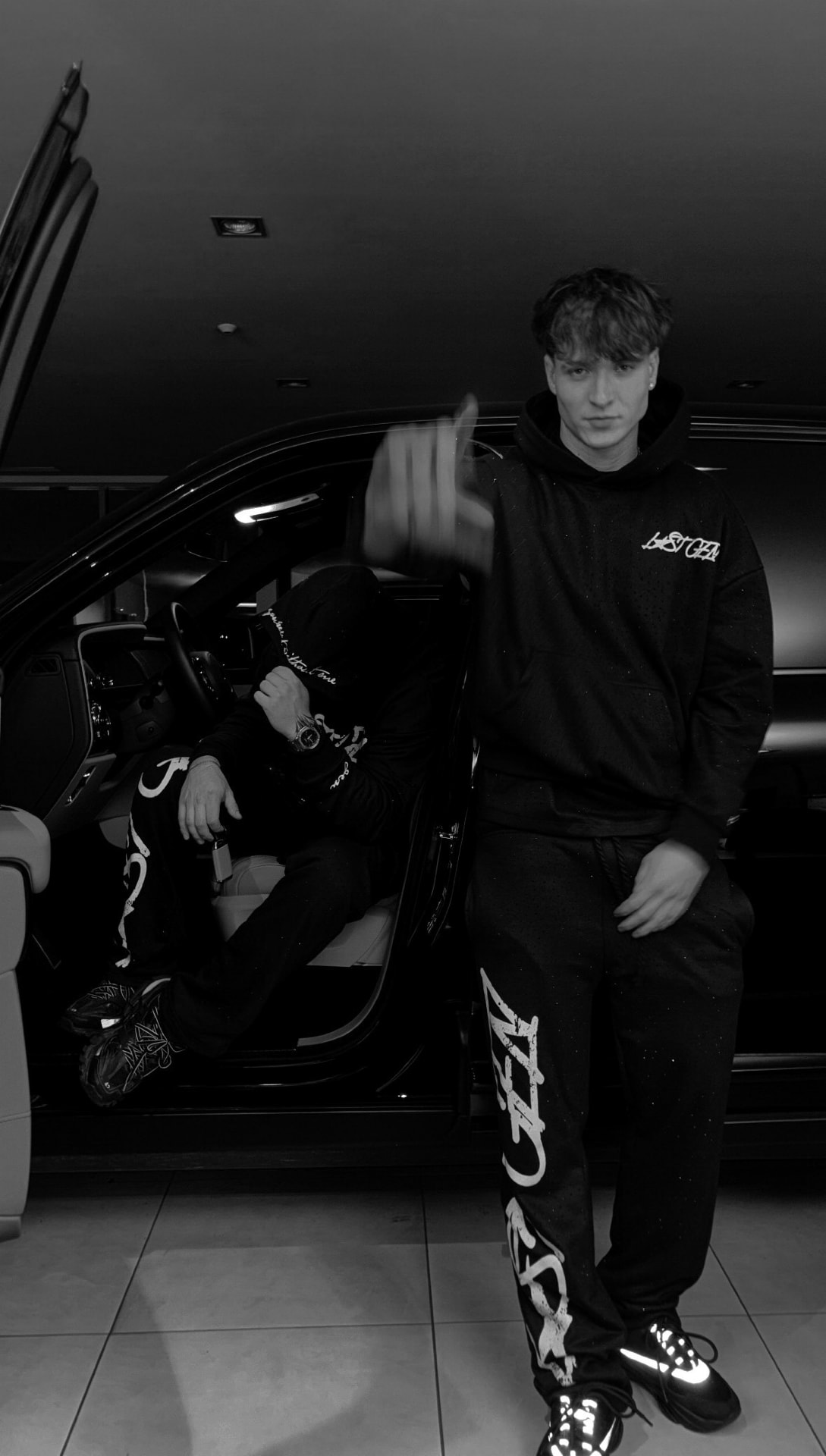 LOSTGEN crew beside a car