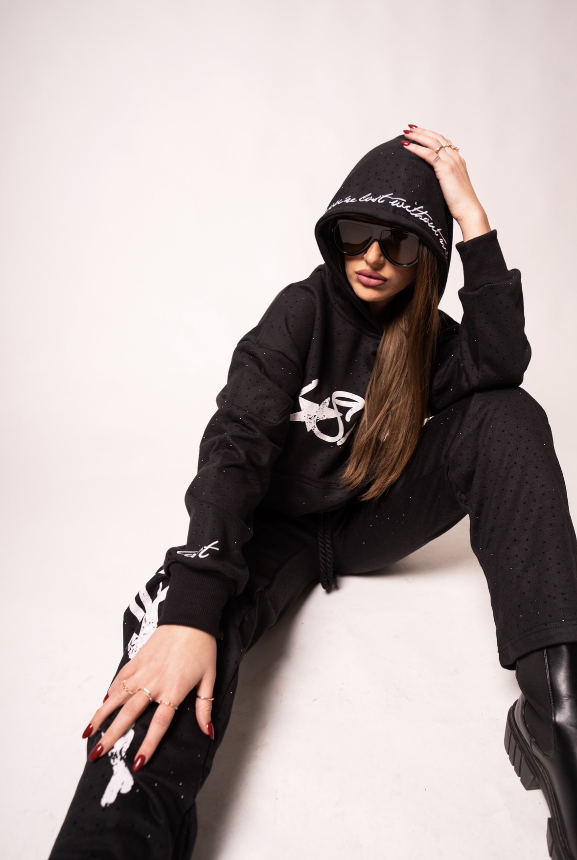 Model in a black LOSTGEN tracksuit