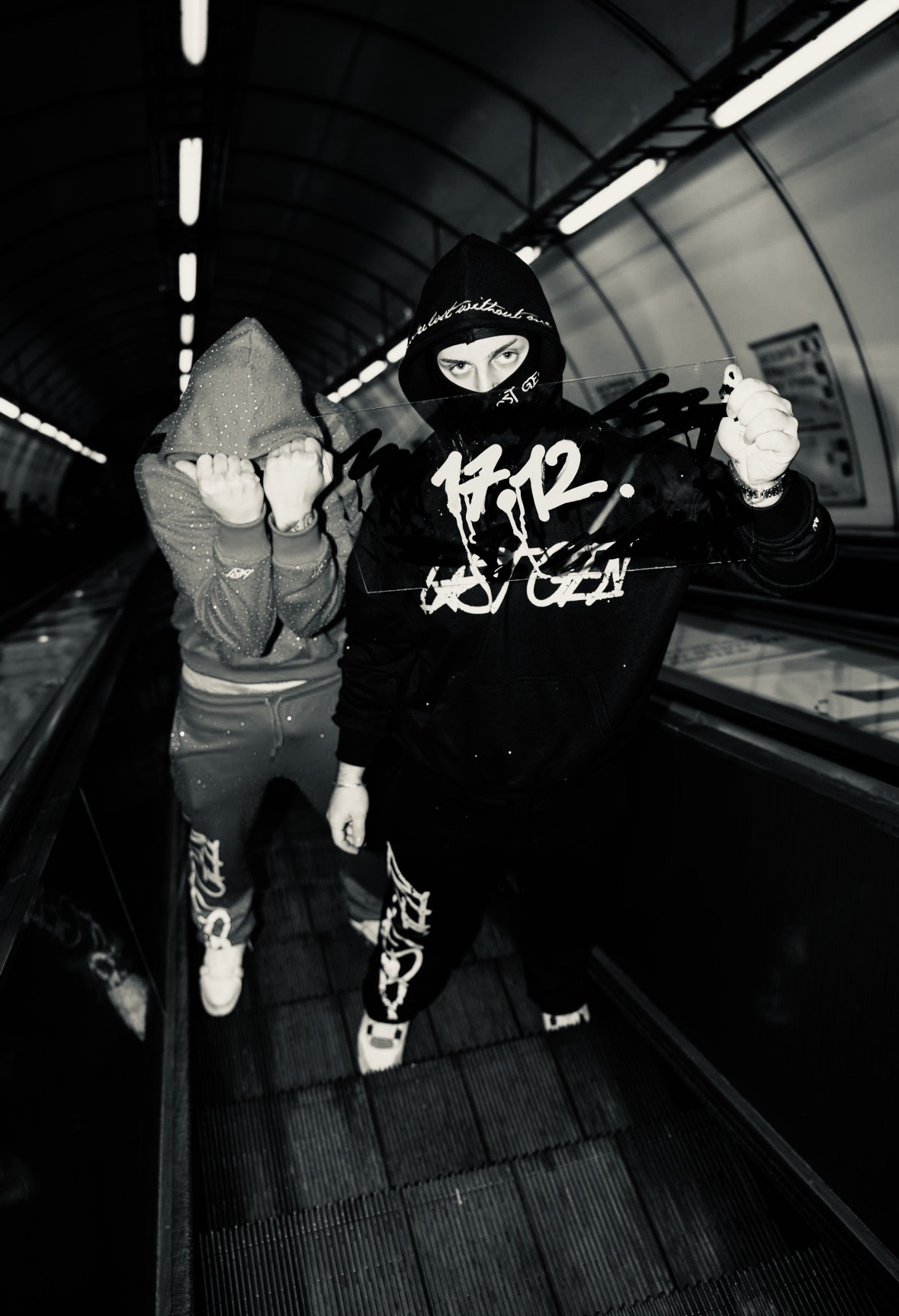 LOSTGEN crew on a metro escalator