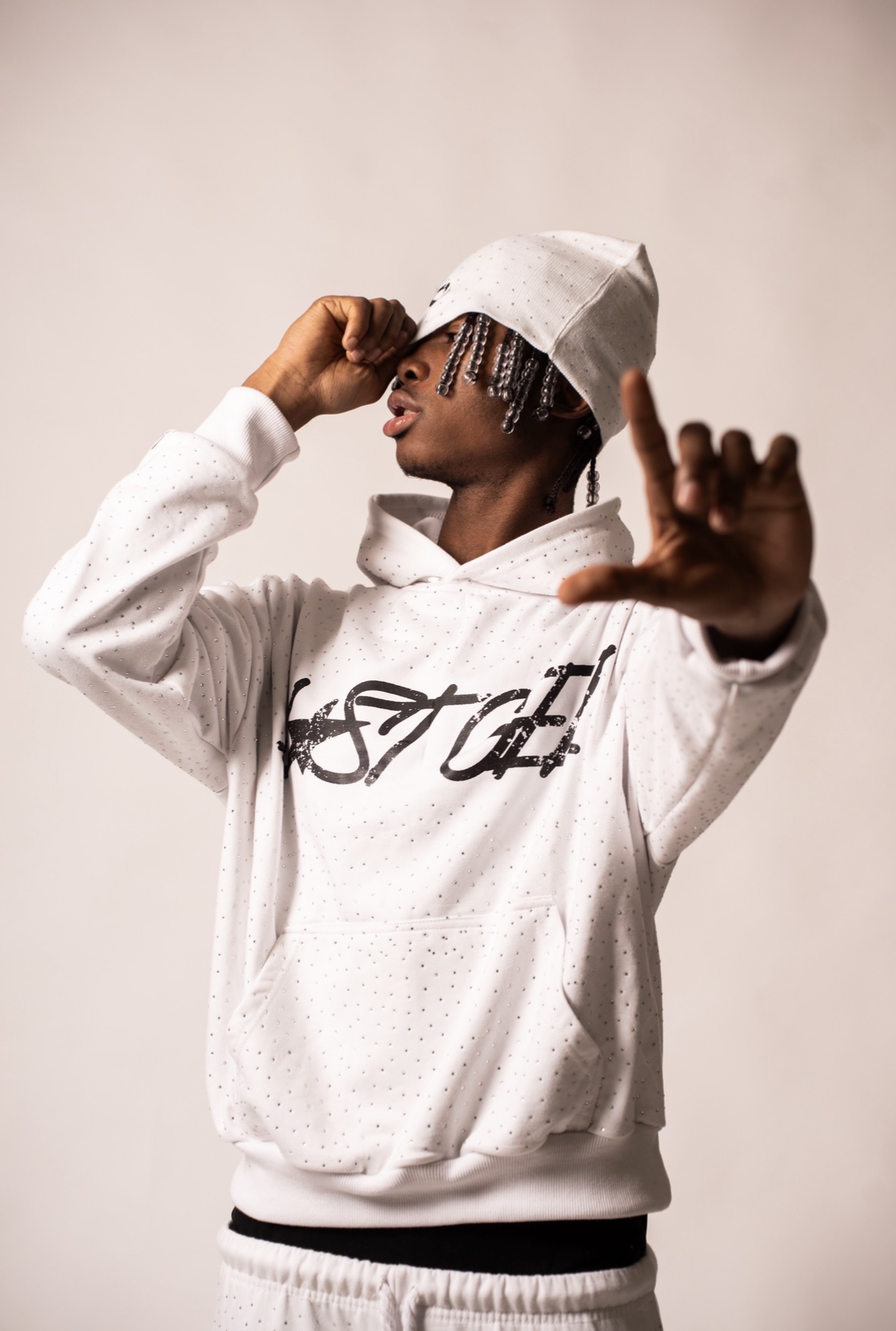 Model in a white LOSTGEN hoodie